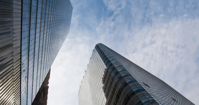 Looking up at glass corporate skyscrapers in a South African central business district — the kind of corporate Euphoria's enterprise phone platform is built to power